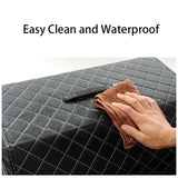 a hand wiping a black quilted mattress