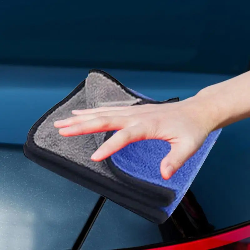 someone cleaning a car with a micro towel and a cloth