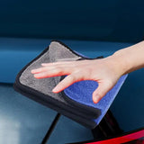 someone cleaning a car with a micro towel and a cloth