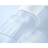 a clear bottle with a white cap