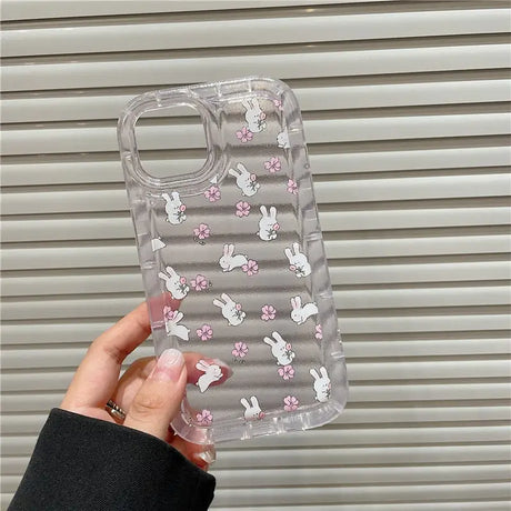 A clear case with pink flowers and bunny ears on it