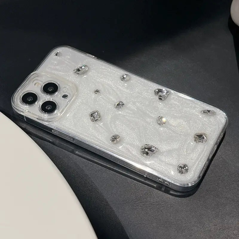 a white phone case with a silver glitter design