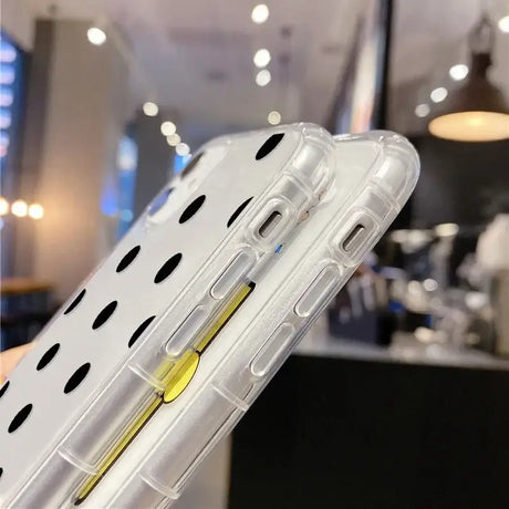 A clear case with a yellow handle