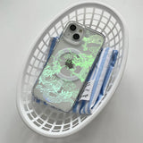 A clear iPhone case with a glowing green dragon design and a MagSafe ring.