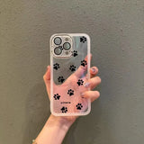 Clear phone case for samsung galaxy with black paw print decals and subtle pink tint transparent back panel