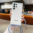 A clear phone case with a camera cutout, lanyard loops, and an attached light blue cord with gold accents.