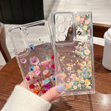 Clear phone case for samsung galaxy with embedded dried flowers in vibrant pink blue and orange on back side