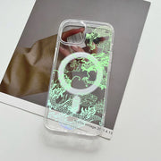 Clear phone case with a glowing green dragon design and a MagSafe ring.