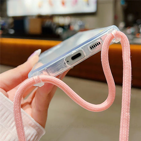 Clear phone case with a pink braided strap