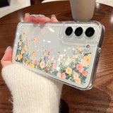 Back side of a protective clear flower case for samsung galaxy with vibrant pink yellow and blue blossoms in liquid compartments