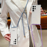 A clear smartphone case with a blue lanyard and a purple strap.