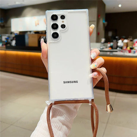 A clear smartphone case with a brown lanyard.