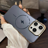 A clear smartphone case with a gold metallic frame, prominent camera cutouts, and a visible MagSafe charging ring and lightning bolt icon.