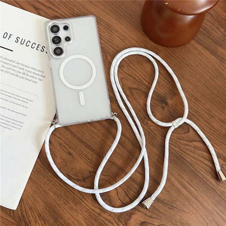 A clear smartphone case with an integrated white circular magnet and an attached white lanyard.