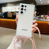 A clear smartphone case with a pink lanyard.