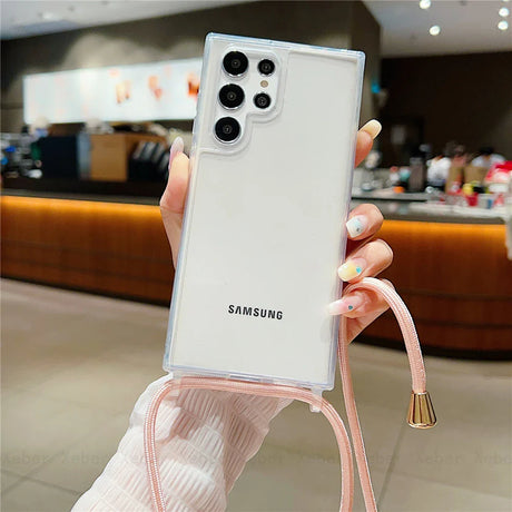 A clear smartphone case with a pink lanyard.