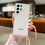 Clear smartphone case with a pink lanyard.