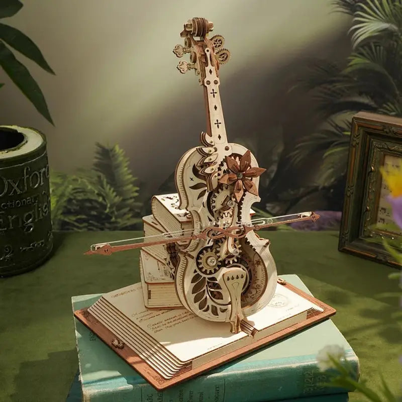 a wooden sculpture of a guitar on top of a book