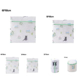 a white toilet bag with a cat design and a green ribbon