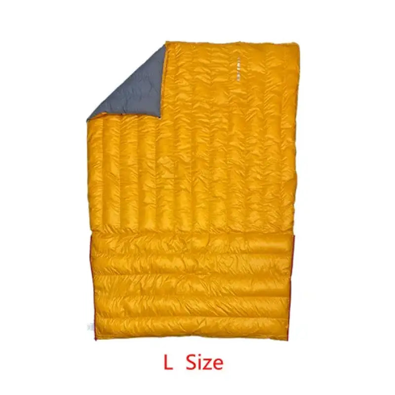 a close up of a sleeping bag with a yellow and blue blanket