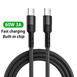 a close up of a black cable with a green tag on it