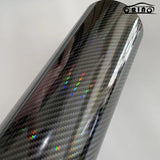 a close up of a black carbon fiber wrapper on a white background
