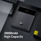 A close up of a black power bank with a yellow card