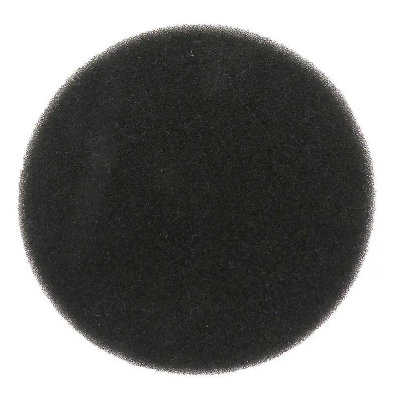 a close up of a black round object on a white surface