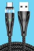 a close up of a black and white cable with a green light