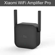 A close up of a black wifi amplifier with a white background