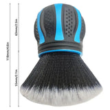 a close up of a brush with a blue handle on a white background