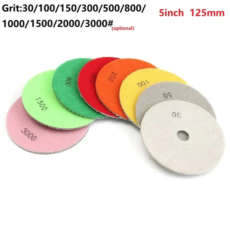 a close up of a bunch of different colored discs on a white surface