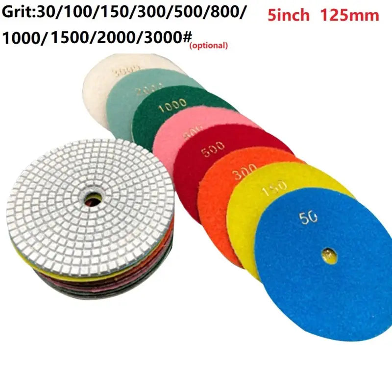 a close up of a bunch of different colored discs on a white surface