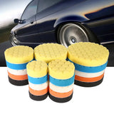 a close up of a bunch of sponges on a table near a car