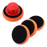a close up of a red button and four black foam pads