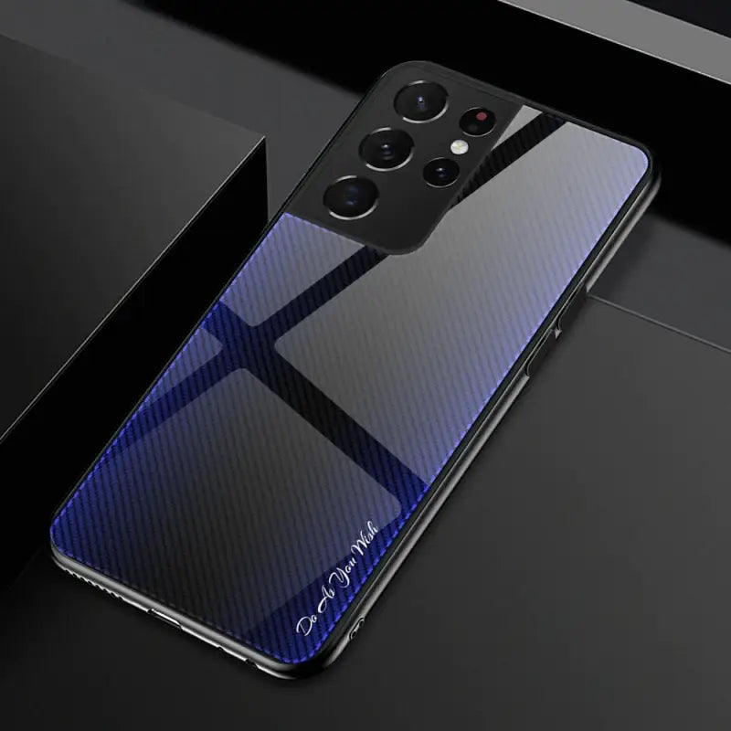 a close up of a cell phone with a blue carbon fiber case