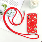 there is a red phone case with a red strap and a flower print
