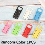 a bunch of colorful plastic clips on a white wooden background