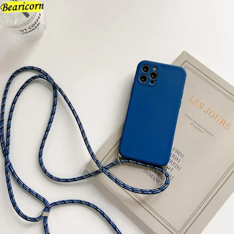 there is a blue phone case with a lanyard attached to it