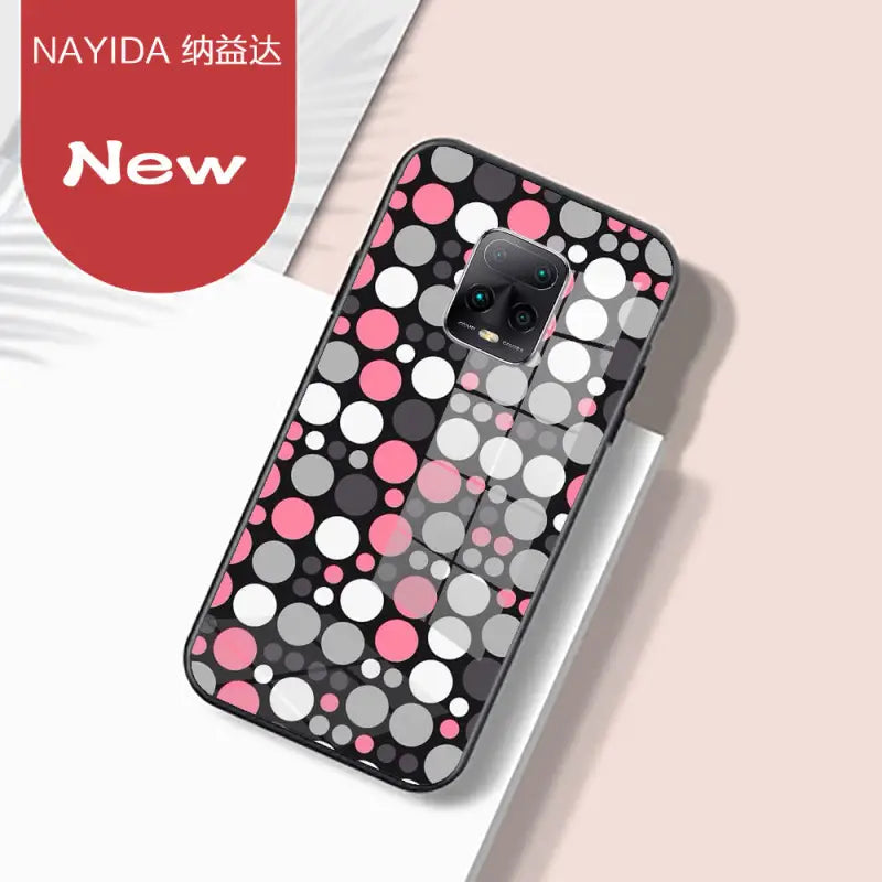 a phone case with a pink and grey polka dot pattern
