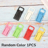 a bunch of colorful plastic clips on a white wooden background