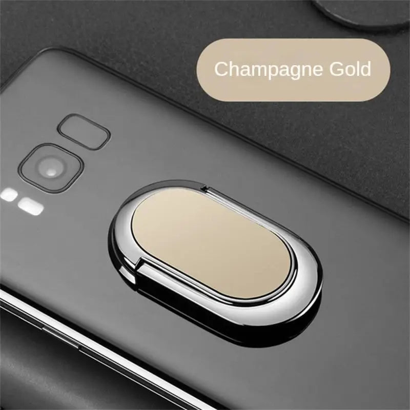 the back of a black samsung phone with a gold ring