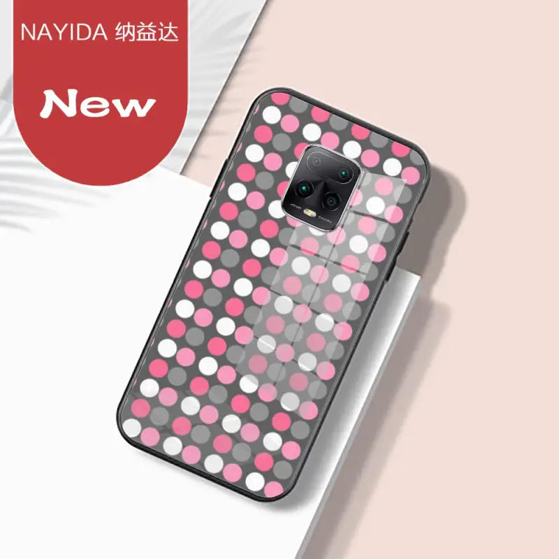 a phone case with pink and grey polka dots
