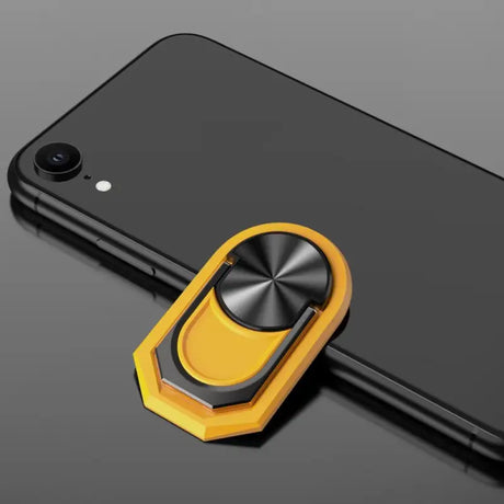 a close up of a cell phone with a ring on it