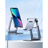 A close up of a cell phone on a stand on a table