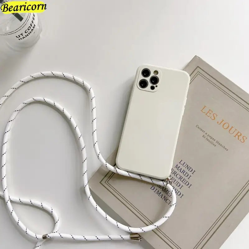 there is a white phone case with a white cord attached to it
