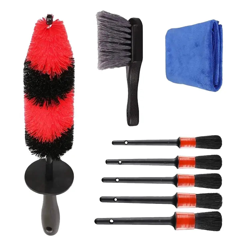 a close up of a set of cleaning tools including a brush, a rag, a sponge, and a cloth