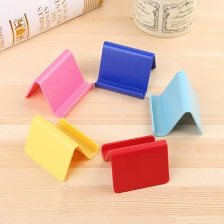 a set of four colorful plastic napkins on a table