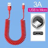 a close up of a red coiled cable connected to a micro usb