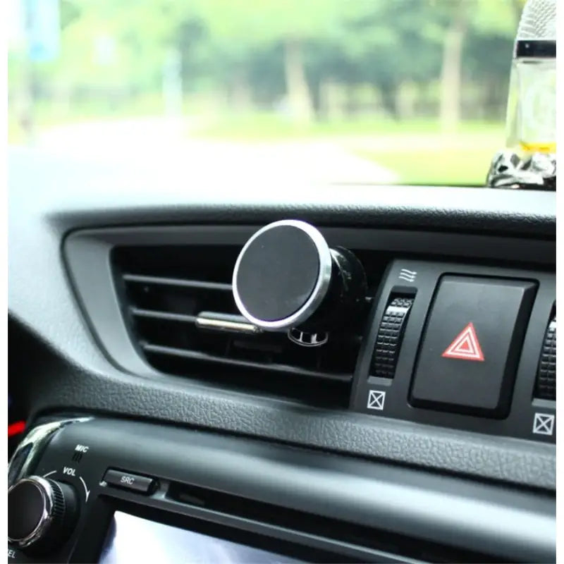 a close up of a car dashboard with a car air vent